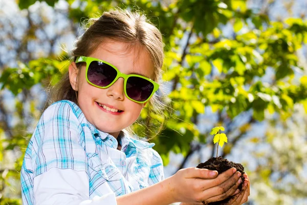 Little girl with seedling — Stock Photo, Image