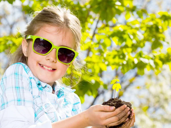 Little girl with seedling — Stock Photo, Image