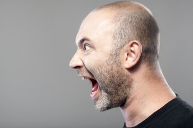 Portrait of angry man screaming isolated on gray background with clipart