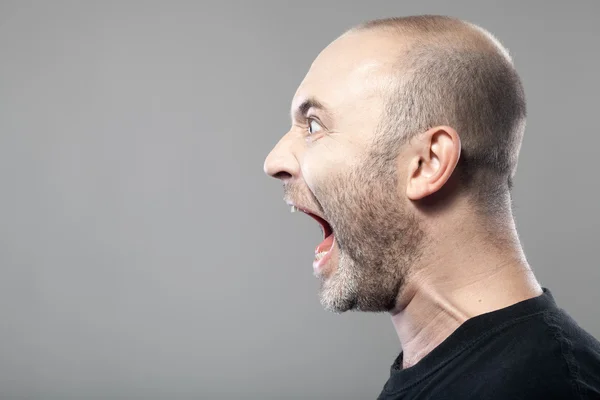 Портрет сердитого чоловіка, що кричить ізольовано на сірому фоні з — стокове фото