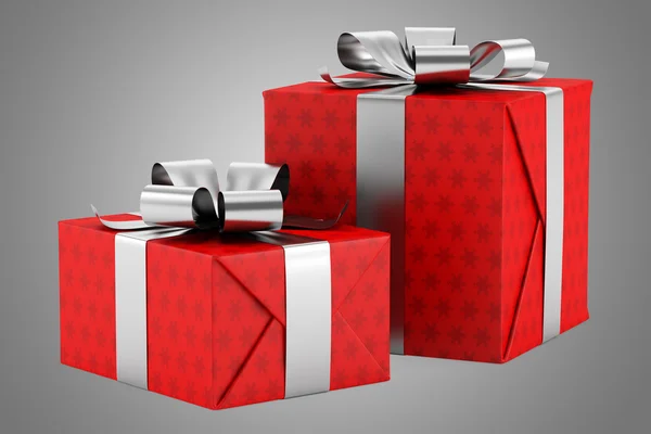 Zwei rote Geschenkboxen mit silbernen Bändern isoliert auf grauem Hintergrund — Stockfoto