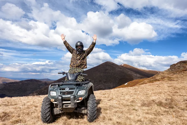 Male rider on ATV at mountain top — Stock Photo, Image