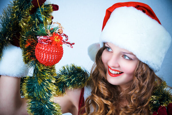 Beautiful woman in a red dress and hat of Santa with a christmas