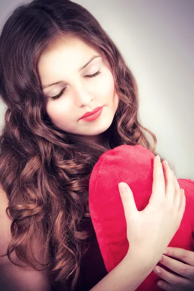 Retrato de hermosa joven con el corazón en las manos — Foto de Stock