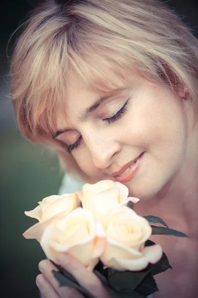 Happy smiling woman with flower Stock Image