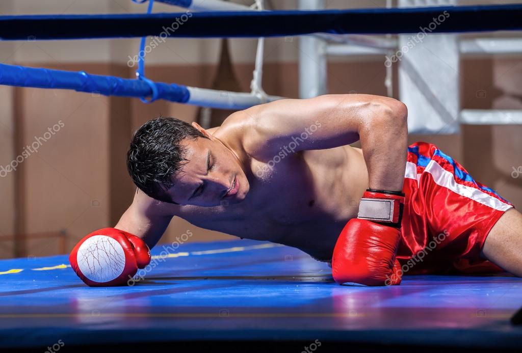 Boxer lying knocked out in a boxing ring Stock Photo by ©anpet2000 13276281