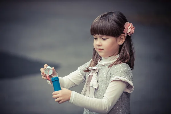 Little girl blowing  bubbles — Stock Photo, Image