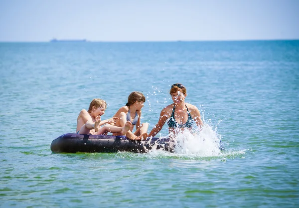 Family  on air bed on sea — Stock Photo, Image