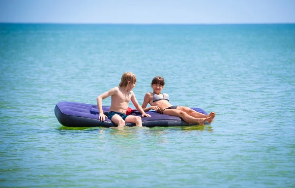 Children   on air bed on sea — Stock Photo, Image