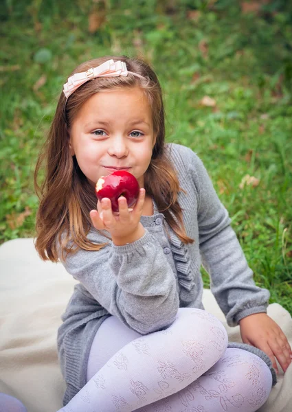 Girl is eating apple — Stock Photo, Image