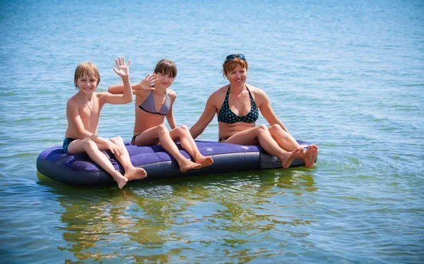 Family  on air bed on sea — Stock Photo, Image