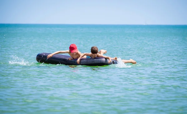 Children   on air bed on sea — Stock Photo, Image