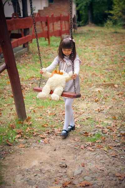 Girl and amusing bear — Stock Photo, Image