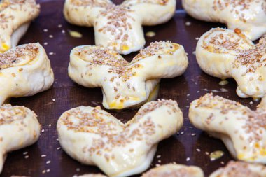 raw biscuits on a baking sheet, ready to cook