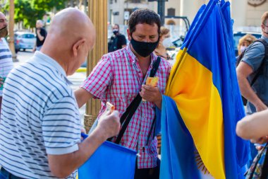 6 Mart 2022 Buenos Aires Arjantin: Rus saldırısı sırasında Ukrayna 'ya destek yürüyüşü yapan bayrak satıcısı