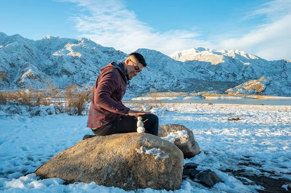 Young Man Making Snowman — 스톡 사진