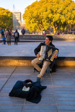 Plaza of Spain in Mendoza, Argentina - July 17, 2022: Street musician in Independence Square (Plaza Independencia), the biggest and most important square in Mendoza city, Argentina 