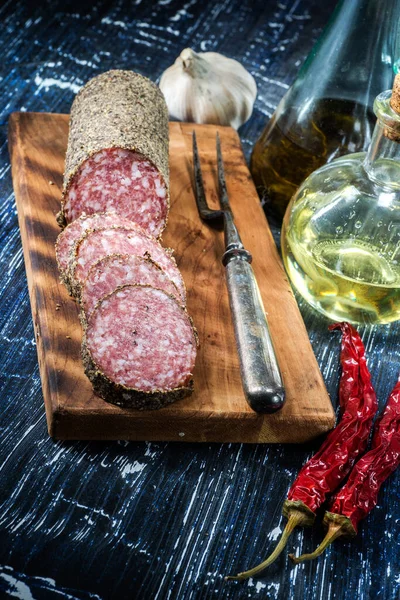 Spicy Salami Sausage Hot Pepper Garlic Olive Oil Blue Table — Stock Photo, Image