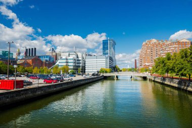 Baltimore. Maryland. USA.  November13. 2021. Baltimore East Harbor canal with modern high-rises and historic buildings. Clouds and blue sky over the city.