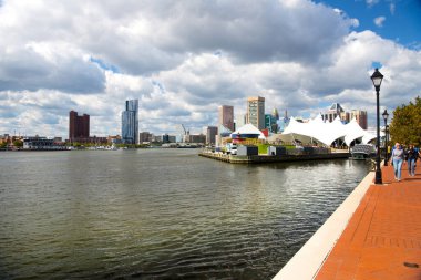  Baltimore Canal East Harbor. Embankment with modern high-rise buildings and historic buildings. Clouds and blue sky over the city.