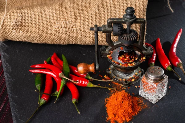 Finely Ground Red Hot Pepper Mill Pepper Pods Black Table — Stock Photo, Image