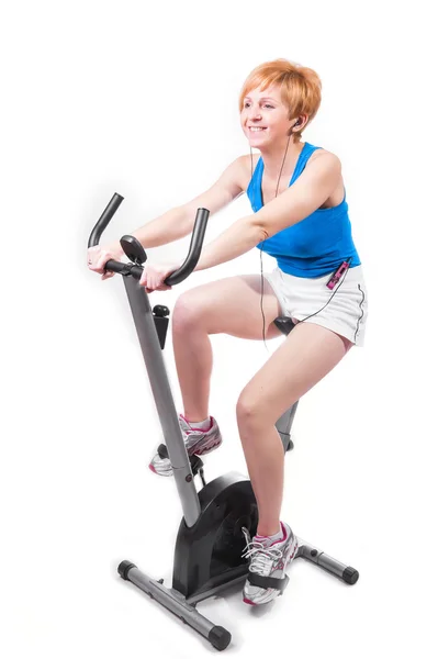 Mujer haciendo deportes en bicicleta estática —  Fotos de Stock