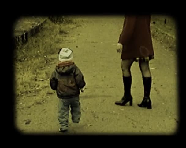 Маленький ребенок играет в осеннем парке — стоковое видео