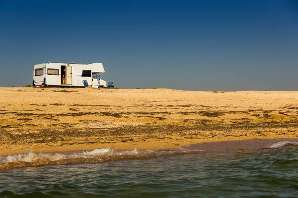 trailer-house on wheels on the Azov sea beach, Arabat spit, Ukraine