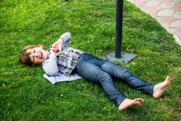 Happy Little Caucassian Girl Laying Green Grass Make Handly Sign — стоковое фото