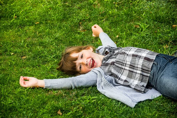 Uma Menina Caucassiana Feliz Deitado Grama Verde — Fotografia de Stock