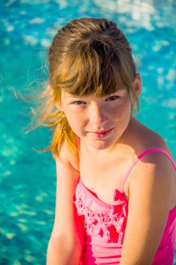a portrait of a little girl in swimming pool
