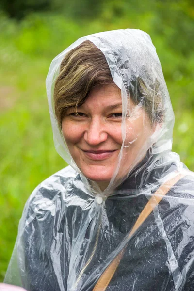 close-up of a portrait of smiley woman in raincoat