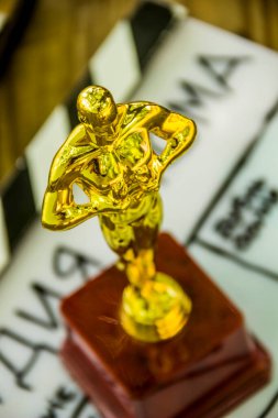 close-up of a decorative oscar figure on blurry film clapper