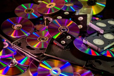 close-up a many compact discs and some hi-8, vhs and dv-cam video casettes panorama