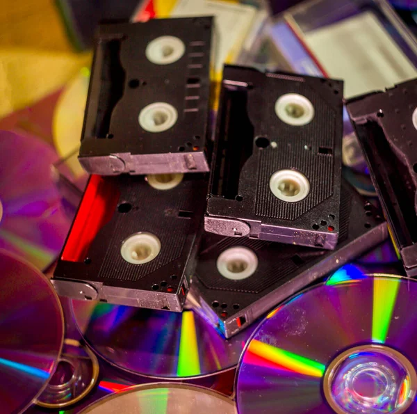 close-up a many compact discs and some hi-8 video casettes with moving lights