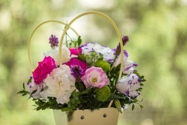 close-up bouquet of lisianthus (eustoma) flowers in decorative plastic basket