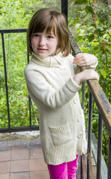 close-up of a happy little giel stay on the terrace