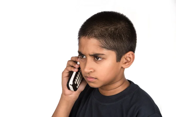 Handsome Indian kid looking very mad talking on phone — Stock Photo, Image