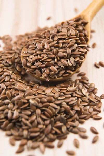 Wooden spoon with flax seed — Stock Photo, Image