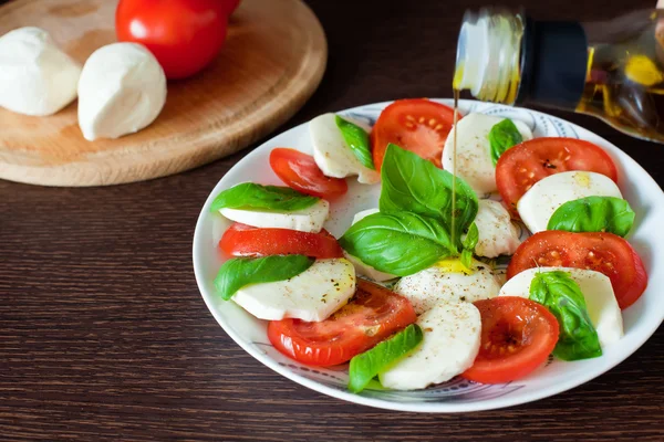 Olive Oil Pouring On Caprese Salad — Stock Photo, Image