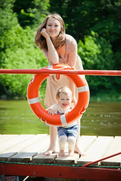 Woman and her daughter posing with buoy — Stock Photo, Image