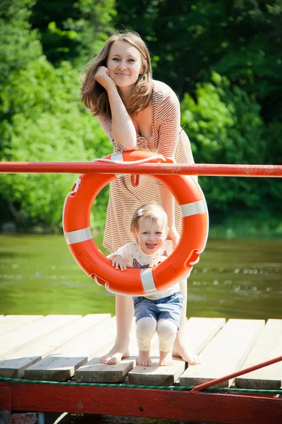 Mulher e sua filha posando com bóia — Fotografia de Stock