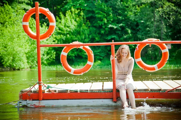 Woman wetting her feet in the river — Stock Photo, Image