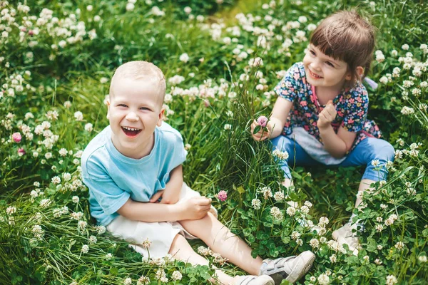 Two Happy Children Friends Boy Girl Sitting Clover Field Having — Stock Photo, Image