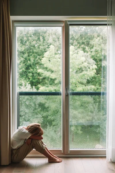 Depressed Woman Sitting Floor Window Embracing Her Knees Lonely Sad — Stock Fotó