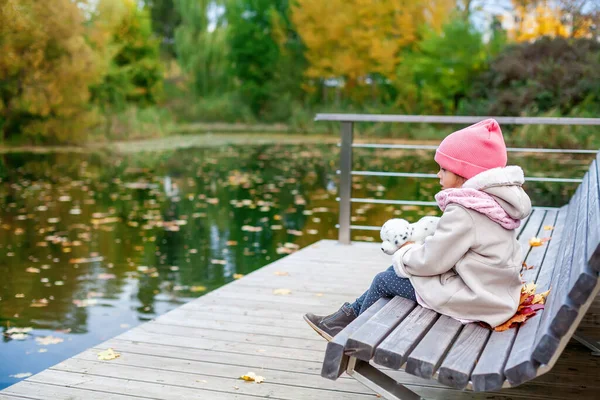 Little Girl Warm Clothes Sitting Bench Autumn Park Looking Leaves — Stock Photo, Image