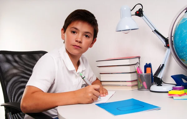 Schoolboy doing his homework — Stock Photo, Image
