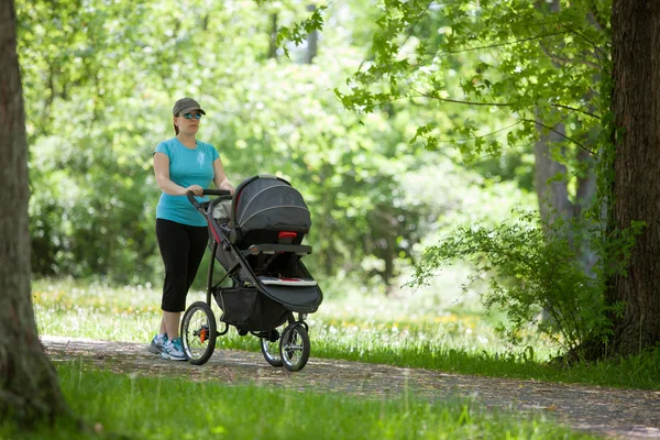 Young woman with a stroller — Stock Photo, Image