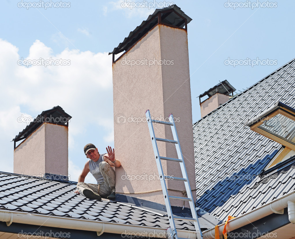 Construction workers repairing roof