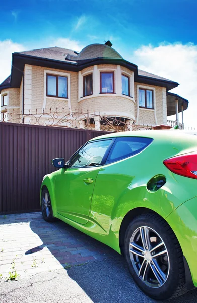 Luxury sport car in front of a house — Stock Photo, Image